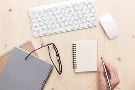 Man write on notebook  Modern  office desk with laptop and other supplies with cup of coffee
for input the text on copy space Top view, flat lay.の写真素材