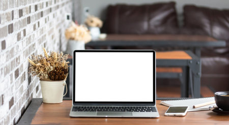 Laptop with blank screen on table.