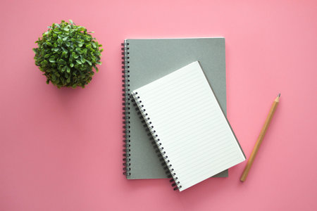 Office desk table with notebook, keyboard, pen, cup of coffee. Top view with copy space.の写真素材