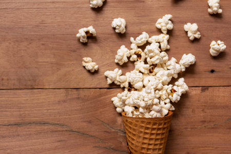 snack popcorn with ice cream Cone on wood backgroundの写真素材