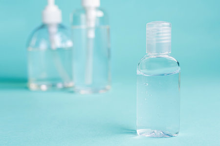 close up small Carry bottle alcohol clean with sanitiser liquid bottle . concenpt protection sanitiser tool protect corona virus on  turqouise isolated backgroundの写真素材