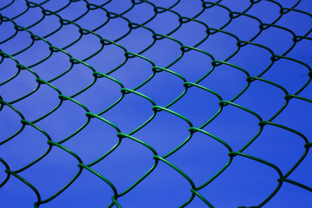 chainlink fence against the background of blue sky