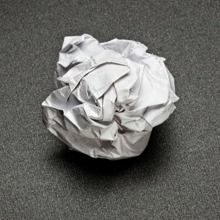 white crumpled paper on a gray table, the failure of unsuccessful projectの写真素材