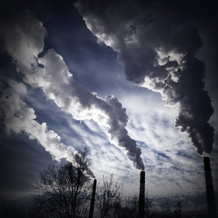 silhouette of chimney-stalks with smokeの写真素材