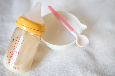 Blank baby bowl , spoon and Bottle of Mother breast milk : concept for baby foodの写真素材