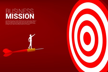 silhouette of businessman standing on arrow dart point forward to dartboard. Business Concept of targeting and customer.Company vision mission.のイラスト素材