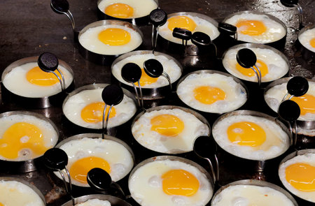fried egg on hot pan cooking. background concept for cooking and breakfast.
