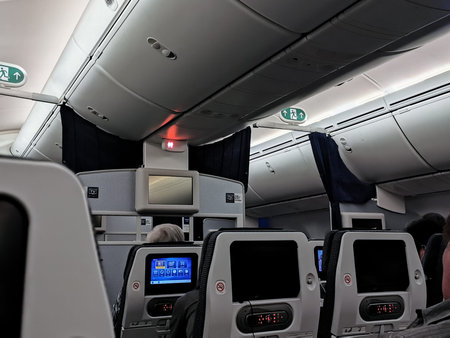 Row of overhead shelf on commercial airplane cabin. Background for travel and transportation...