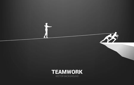 Silhouette of businessman walking on rope walk way pulled by team.Concept for teamwork and team support..のイラスト素材