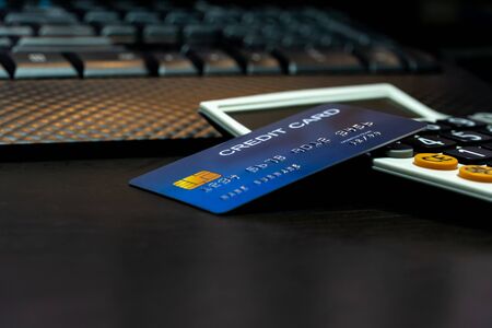 Shallow focus Credit Card on Computer keyboard and calculator. Background for E-commerce and online shopping concept.の写真素材