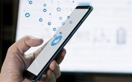 mobile phone in hand with monitor background and bubble like icon flow. Concept for mobile...