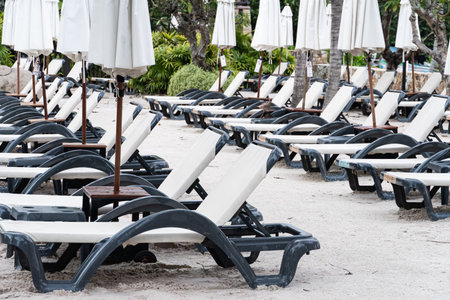 row of white daybed on the beach. background for thailand travel and relaxation