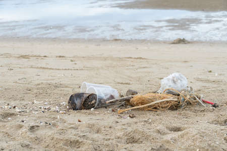 Plastic and garbage on dirty beach. Concept for beach and ocean pollution and environment.の写真素材