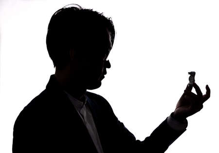 shilhouette of businessman hold chess piece. concept of business strategy and marketing planの写真素材