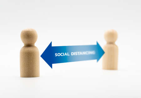 Distance between wooden human icon. Concept of social distancing and isolation.の写真素材
