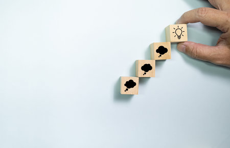 Top view wooden blocks set to step from thinking to idea. Concept for creative and design thinking.