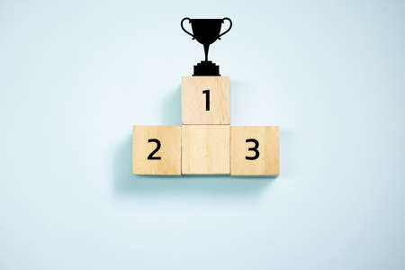 Top view trophy on top of wooden blocks  set  to podium. Concept for success and teamwork.の写真素材