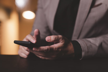 Close up hand of businessman with mobile phone. Concept of technology for business.