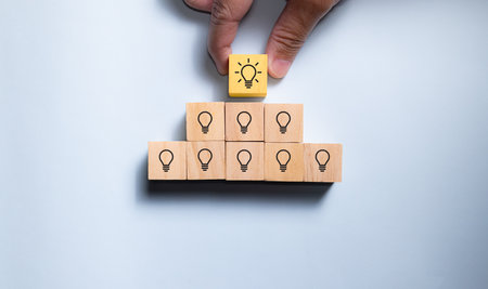 Top view wooden blocks with working people to trophy. Concept for work hard and success career.の写真素材