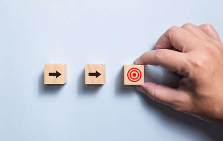 Top view wooden blocks set to step with icon arrow to target. Concept for growth business and targeting.の写真素材