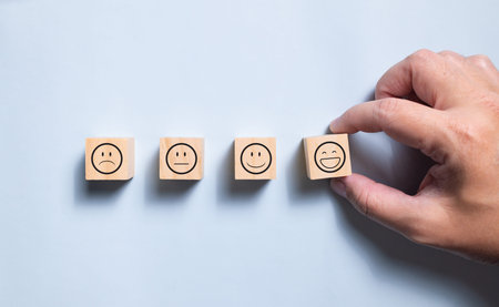 Top view wooden blocks with smiley face graphic. Concept for rating and customer satisfaction.の写真素材