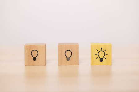 wooden blocks with light bulb in the row. Concept for creative and design solution.の写真素材