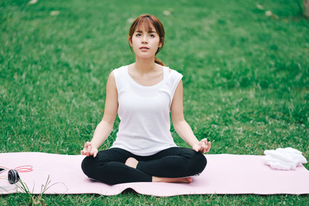 Woman relaxing Yoga in the parkの写真素材