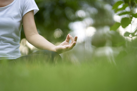 Woman relaxing Yoga in the parkの写真素材