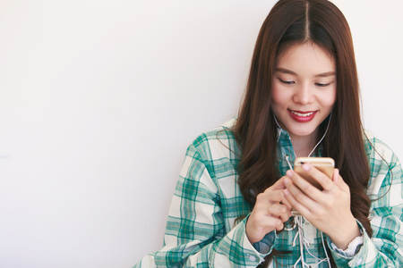 Happy Woman listen to music via smartphoneの写真素材