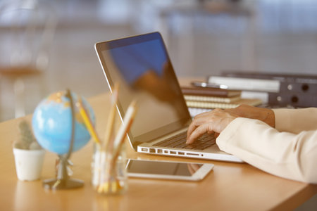 Business woman typing on laptop at workplace Woman working in home office hand keyboard, Hands of...