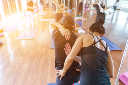 Group women asian doing stretching yoga hot exercises with instructor in studioの写真素材