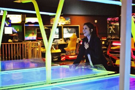 a young adult playing aero hockey in Houston, Texasの写真素材