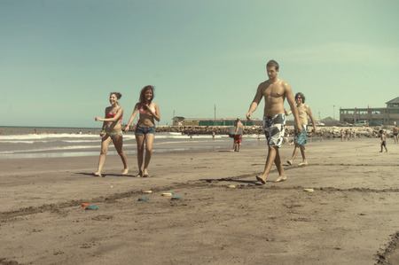 Mar del Plata, Argentina - February 12, 2013: A family playing Tejos, an argentinian game similar to quoits in a beach of Mar del Plata.のeditorial素材