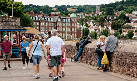 Minehead, UK - July 27, 2016: People walking and enjoying a summer day in a shoreside in Minehead, UK.のeditorial素材