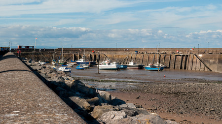 Boats at low tide in Minehead harboard,  Minehead, Somerset, UK.のeditorial素材