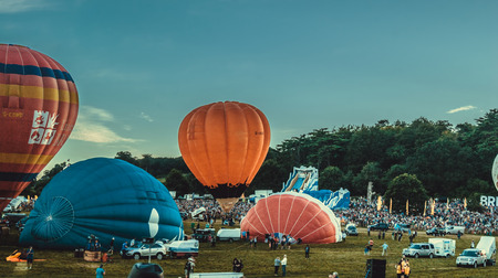 Bristol, UK - August 13, 2016: The Bristol International Balloon Fiesta 2016, showing the mass ascent and landings of over 100 balloons including special shapes and the 'night glow', where the burners are used at night to illuminate the balloons. This annのeditorial素材