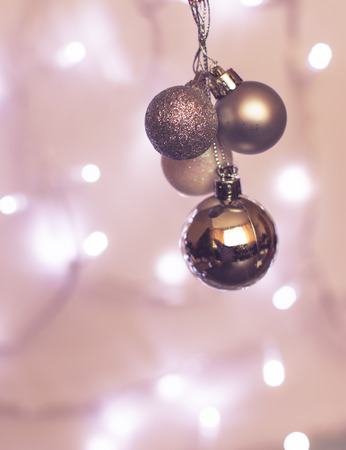 shiny, silver and white baubles and defocused lights in the background.の写真素材