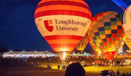 Bristol, UK - August 13, 2016: The Bristol International Balloon Fiesta 2016, showing the mass ascent and landings of over 100 balloons including special shapes and the 'night glow', where the burners are used at night to illuminate the balloons. This annのeditorial素材