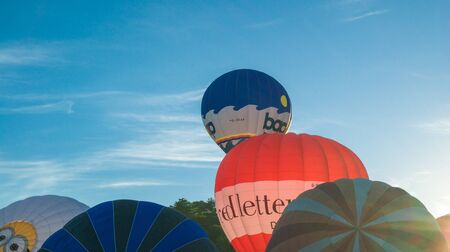 Bristol, UK - August 13, 2016: The Bristol International Balloon Fiesta 2016, showing the mass ascent and landings of over 100 balloons including special shapes and the 'night glow', where the burners are used at night to illuminate the balloons. This annのeditorial素材
