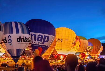 Bristol, UK - August 13, 2016: The Bristol International Balloon Fiesta 2016, showing the mass ascent and landings of over 100 balloons including special shapes and the 'night glow', where the burners are used at night to illuminate the balloons. This annのeditorial素材