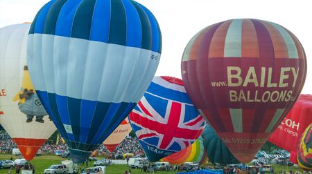 Bristol, UK - August 13, 2016: The Bristol International Balloon Fiesta 2016, showing the mass ascent and landings of over 100 balloons including special shapes and the 'night glow', where the burners are used at night to illuminate the balloons. This annのeditorial素材