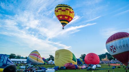 Bristol, UK - August 13, 2016: The Bristol International Balloon Fiesta 2016, showing the mass ascent and landings of over 100 balloons including special shapes and the 'night glow', where the burners are used at night to illuminate the balloons. This annのeditorial素材