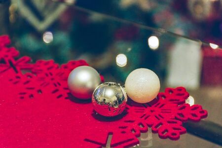 Christmas balls on glass table, nice details of holiday decorationsの写真素材