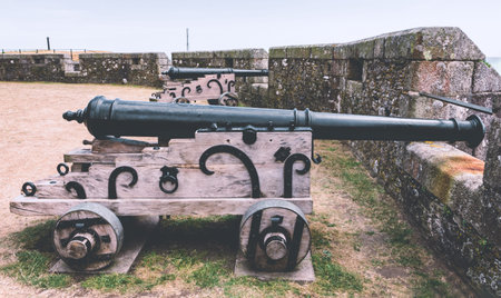 Falmouth, Cornwall, England - July 25, 2018: Historic military artillery gun at Pendennis castle was first commissioned by King Henry VIII in response to invasion threats from the continent.のeditorial素材