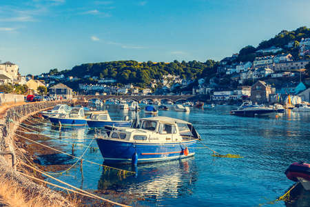 Looe,  Cornwall, England - July 25, 2018: View of the pretty historic Cornish fishing village of Looe with the harbour, fishing boats, fish market and cottages.のeditorial素材