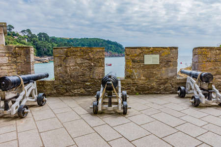 26 July 2018 - Dartmouth, Devon, UK: Canon at Dartmouth Castle on the estuary of the river Dart, Devon. The Castle is an artillery fort, built to protect Dartmouth harbour. The earliest parts of the castle date from the 1380sのeditorial素材