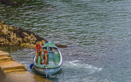 26 July 2018 - Dartmouth, Devon, UK: Coast guards arriving in Dartmouth, Devon. Dartmouth is a town and civil parish in the English county of Devon. It is a tourist destination set on the western bank of the estuary of the River Dart, which is a long narrのeditorial素材