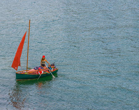 26 July 2018 - Dartmouth, Devon, UK: Family dressed as pirates in River Dart. The River Dart is a river in Devon, England which rises high on Dartmoor, and releases to the sea at Dartmouth.のeditorial素材