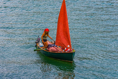 26 July 2018 - Dartmouth, Devon, UK: Family dressed as pirates in River Dart. The River Dart is a river in Devon, England which rises high on Dartmoor, and releases to the sea at Dartmouth.のeditorial素材