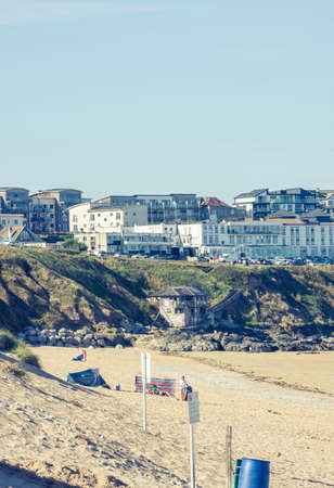 25 July 2018: Marazion, Cornwall, UK-Tourists walk along the beaches of Marazion, an ancient market town in Cornwall, England.のeditorial素材